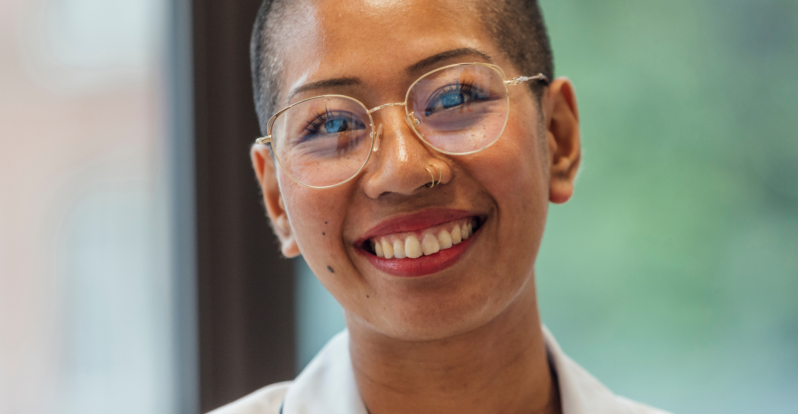 Close-up of a smiling person with glasses.