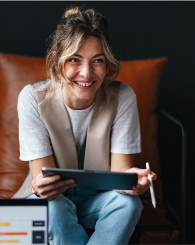 A smiling woman using an iPad