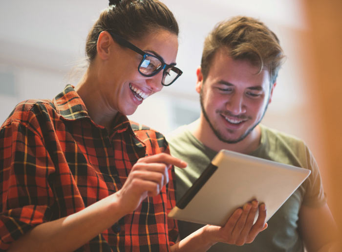 Woman and man looking at tablet