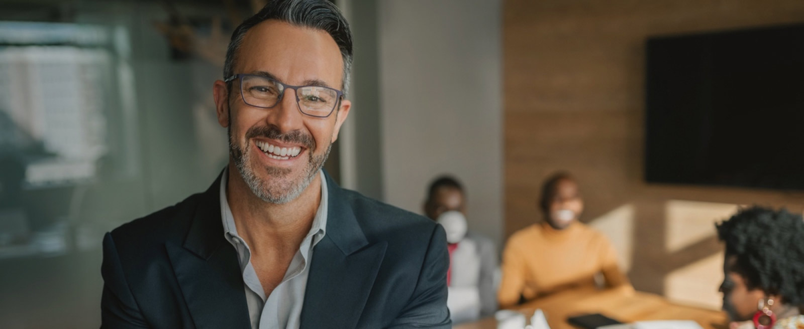 Smiling man with suit and glasses