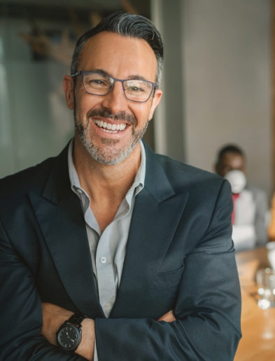 Smiling man with suit and glasses