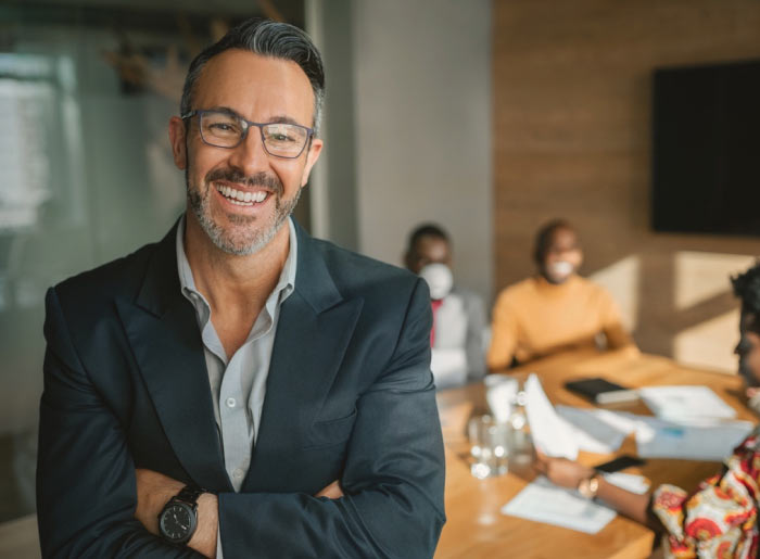 Smiling man with suit and glasses