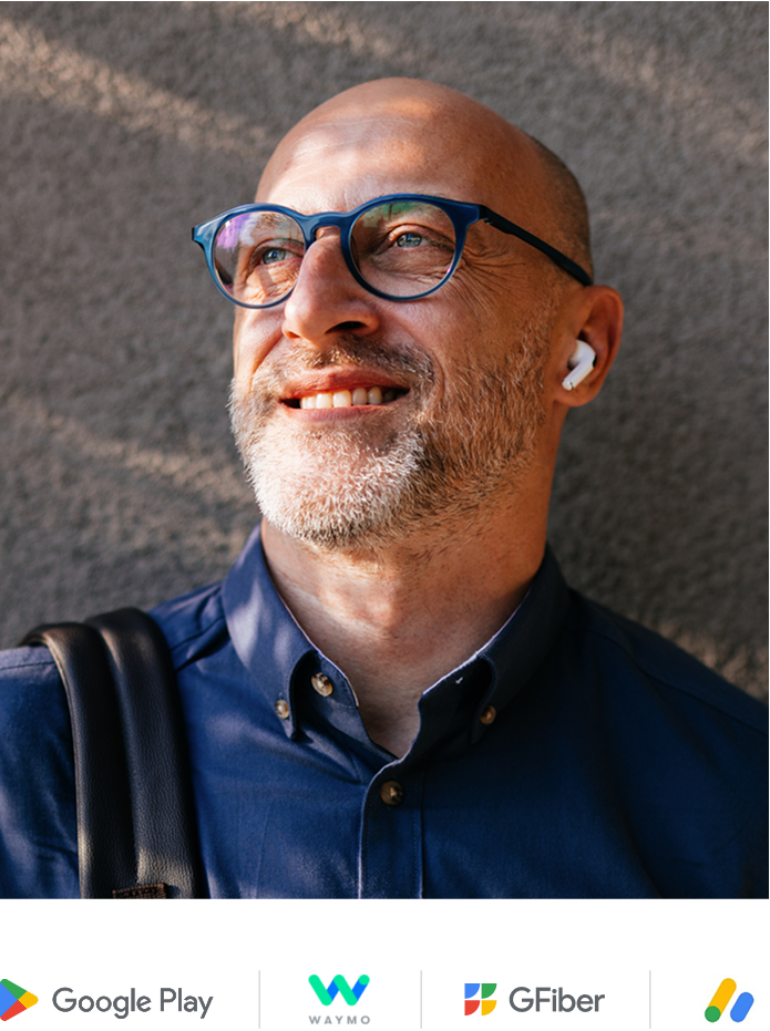 Man with glasses and blue button up shirt smiling