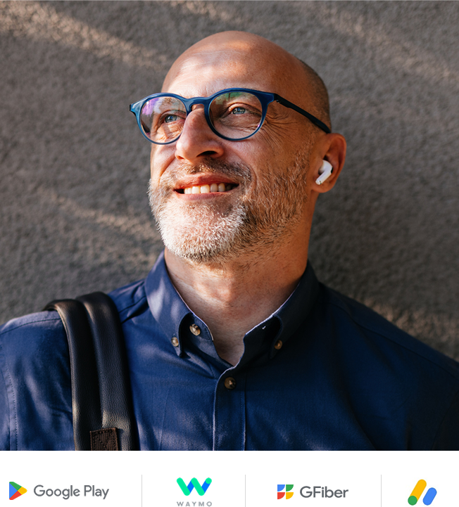 Man with glasses and blue button up shirt smiling