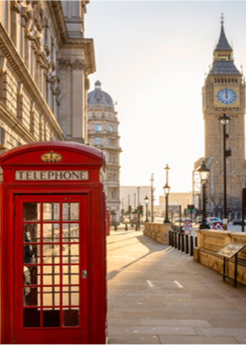 red phone booth with clock tower in background